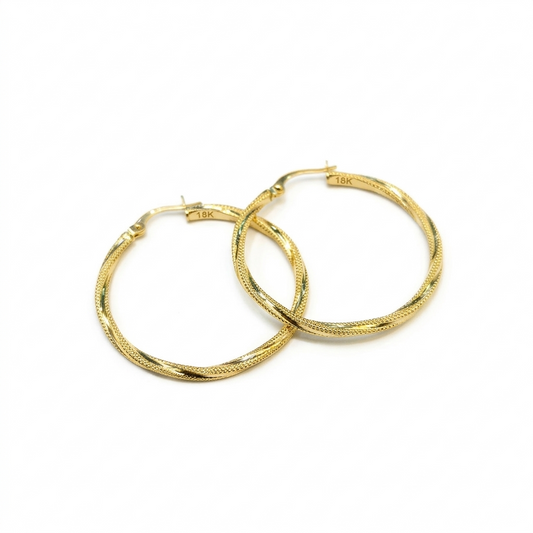Gold hoop earrings on a white background