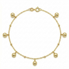 Gold bracelet with spherical charms on a white background