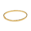 Gold bangle on a white background
