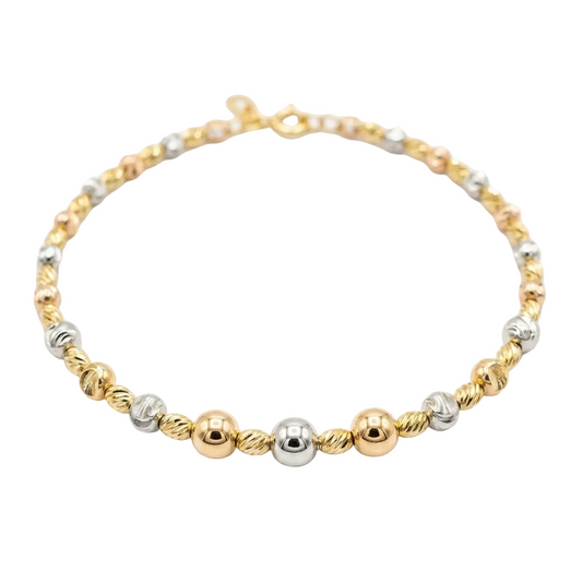 Bracelet with gold and silver beads on a white background