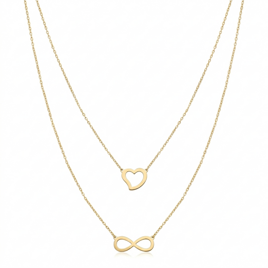 Two gold necklaces with heart and infinity symbol pendants on a white background