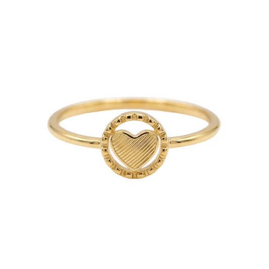 Gold ring with a heart design on a white background
