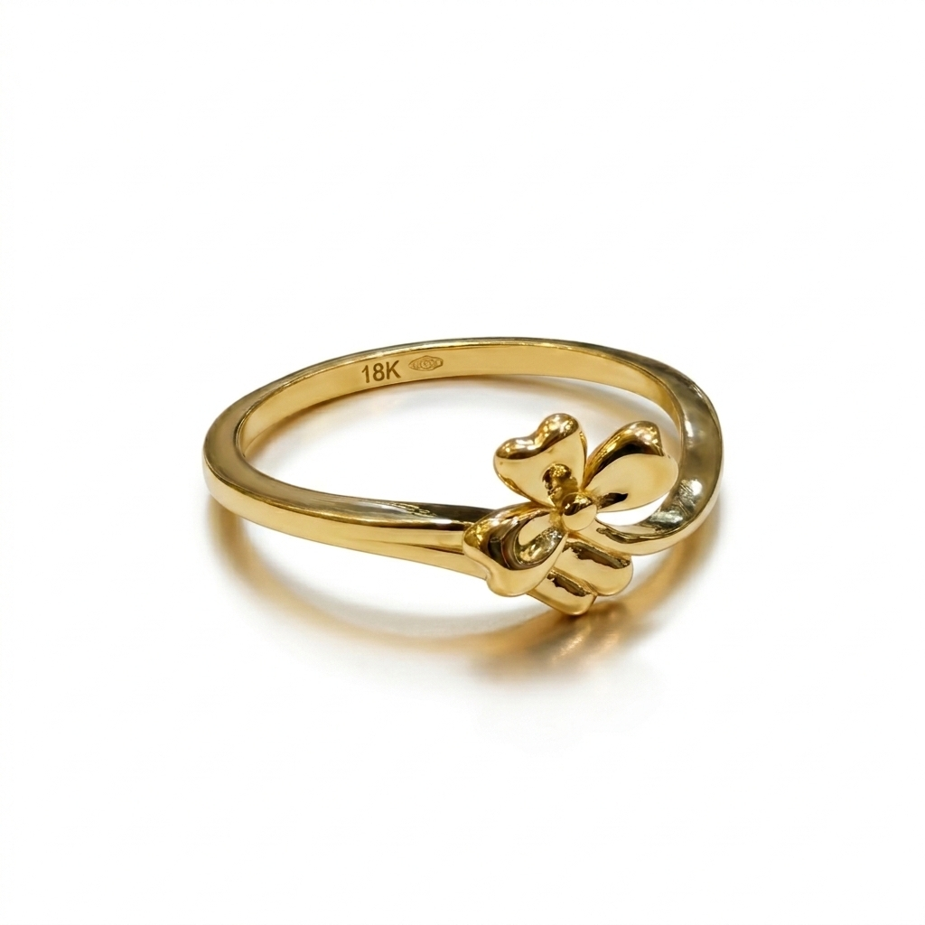 Gold ring with a fleur-de-lis design on a white background