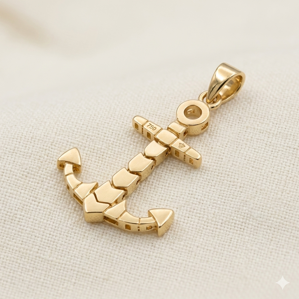 Gold anchor pendant on a light fabric background