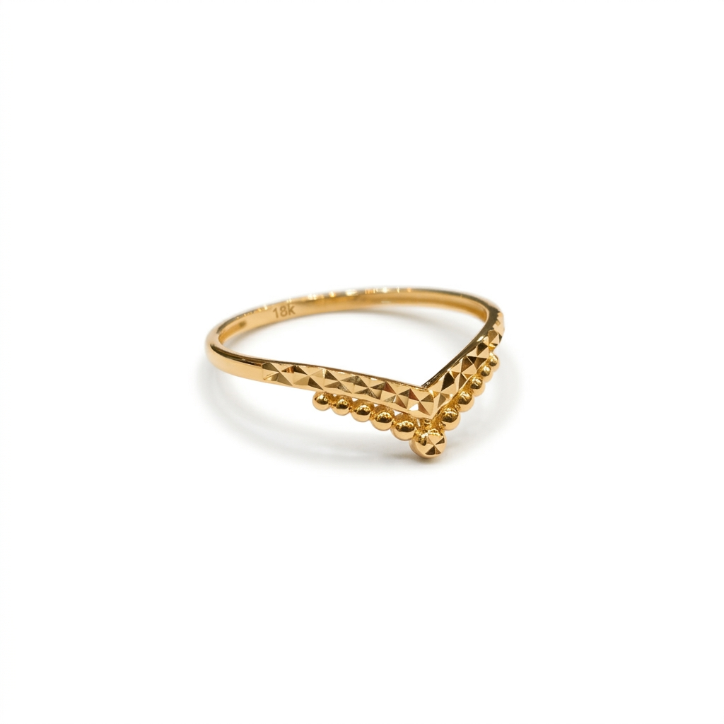 Gold ring with a geometric design on a white background