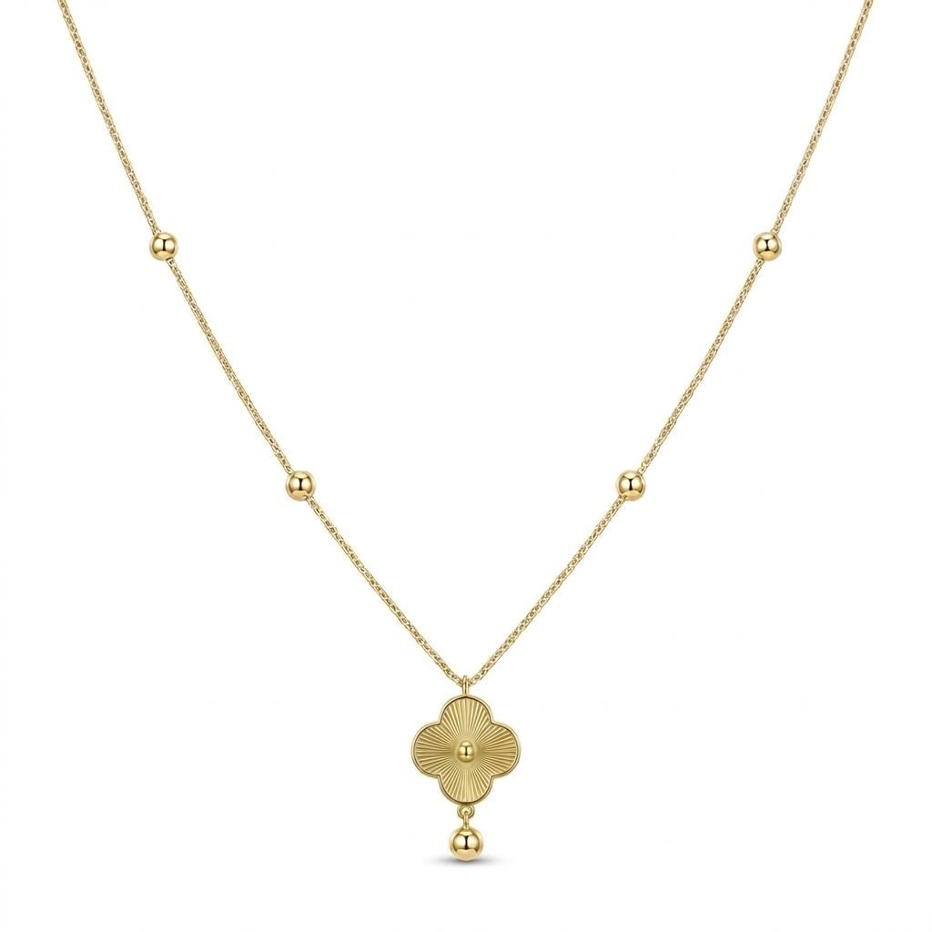Gold necklace with a clover-shaped pendant on a white background