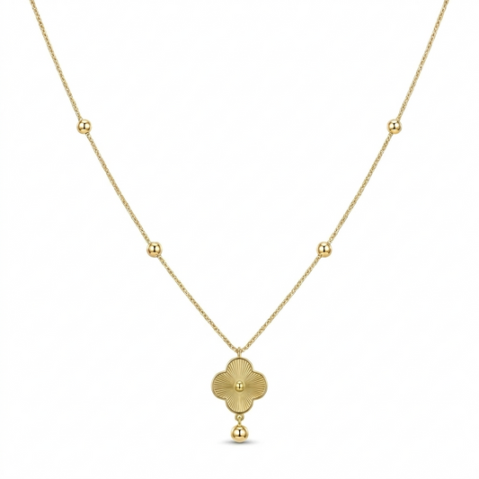Gold necklace with a clover-shaped pendant on a white background