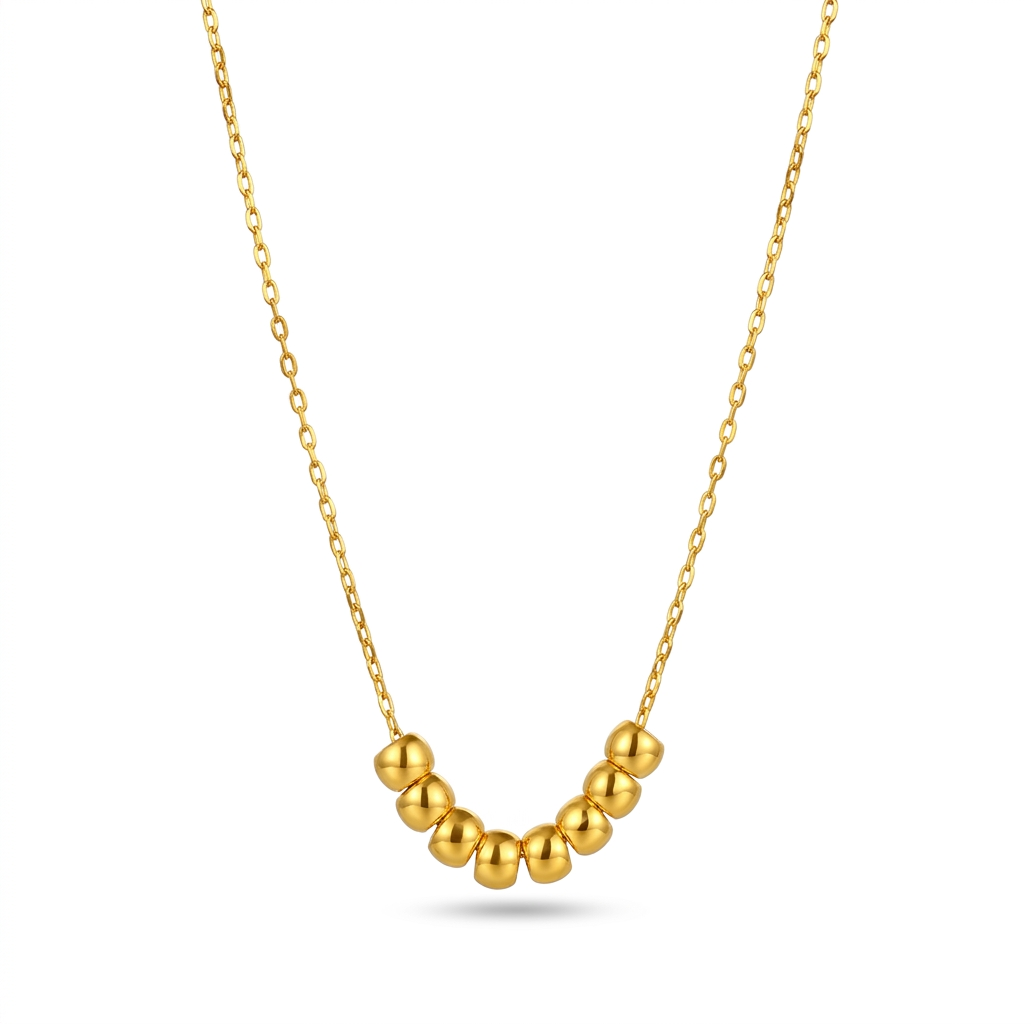 Gold necklace with round beads on a white background