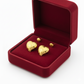 Heart-shaped gold earrings in a red velvet jewelry box, elegant and stylish design