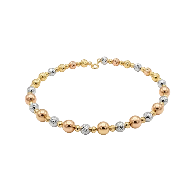 Three-tone gold, silver, and rose gold beaded bracelet on a white background
