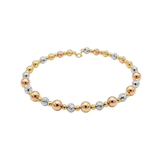 Three-tone gold, silver, and rose gold beaded bracelet on a white background