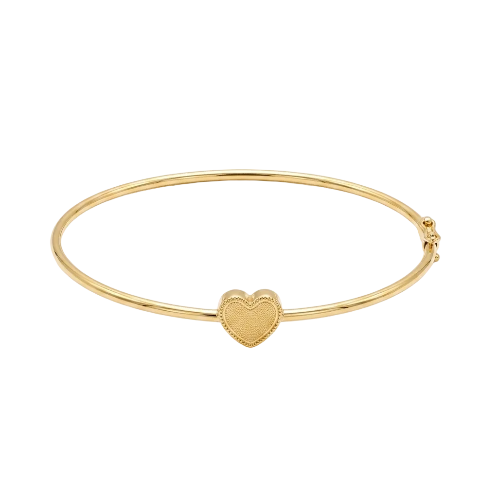 Gold bangle with a heart charm on a white background