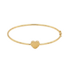 Gold bangle with a heart charm on a white background