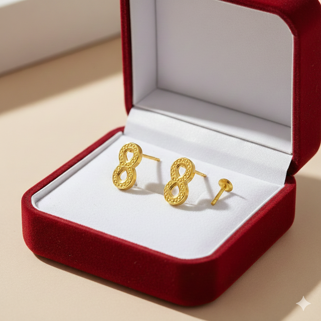 Gold stud earrings with textured infinity design in a red velvet jewelry box