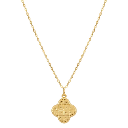 Gold necklace with a clover-shaped pendant on a white background