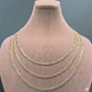 Gold chain necklace on a mannequin bust against a gray background