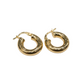 Gold hoop earrings on a white surface