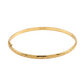 Gold bracelet with intricate design on a white background