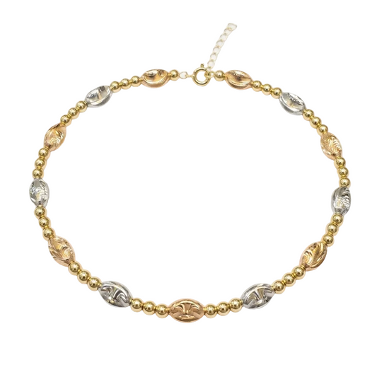Gold and silver beaded necklace on a white background
