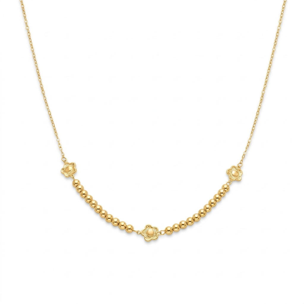Gold necklace with small floral clasp on a white background