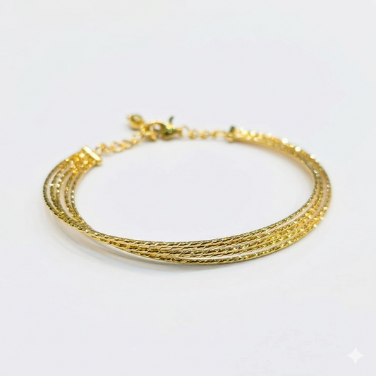 Gold bracelet on a white background