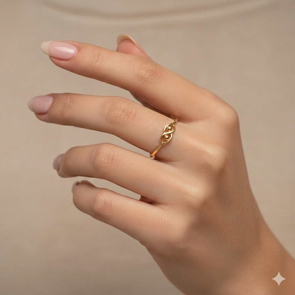 Gold ring on a hand against a beige background