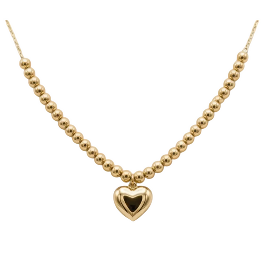 Gold necklace with a heart pendant on a mannequin bust.