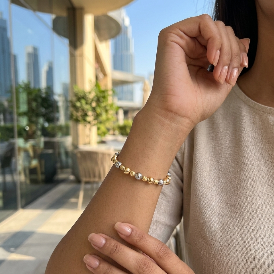 Person wearing a beaded bracelet with a cityscape in the background
