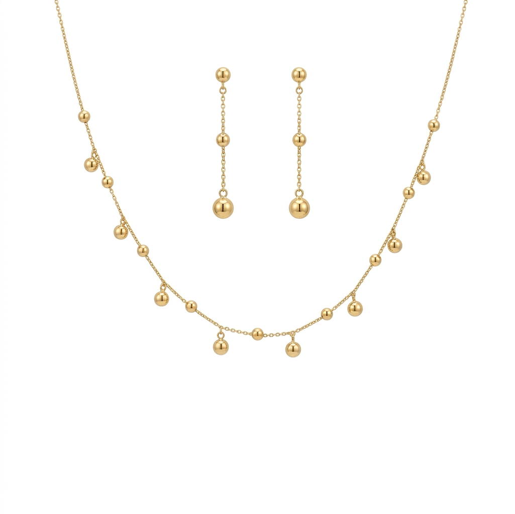 Gold necklace and earrings set on a white background