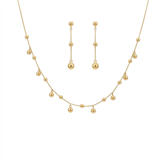Gold necklace and earrings set on a white background
