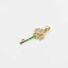 Gold key-shaped pendant with a textured design on a light gray background