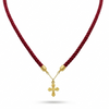 Red cord necklace with a gold cross pendant on a white background