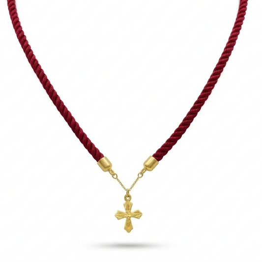 Red cord necklace with a gold cross pendant on a white background