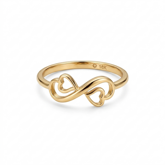 Gold ring with heart and infinity design on a white background