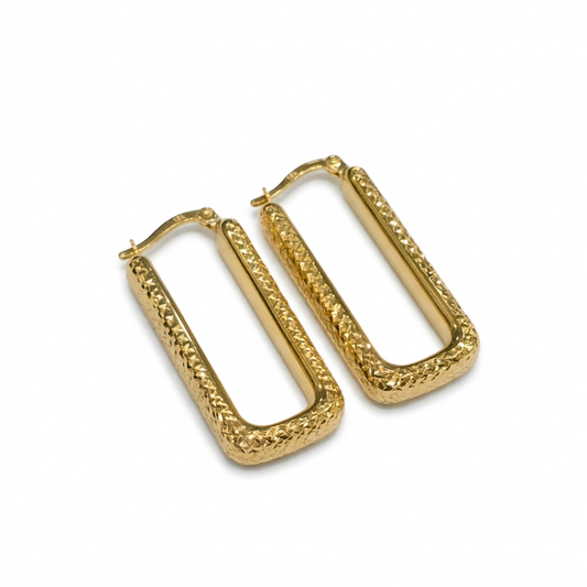 Gold hoop earrings with textured design on a white background
