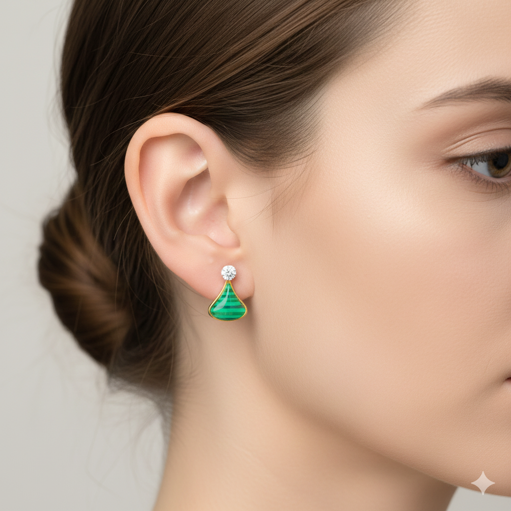 Woman wearing a green gemstone gold earring with diamond accent, close-up view