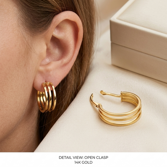 Gold hoop earrings worn and displayed on a neutral background