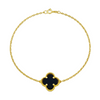 Gold bracelet with a black clover-shaped charm on a white background