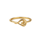 Gold ring with a floral design on a white surface