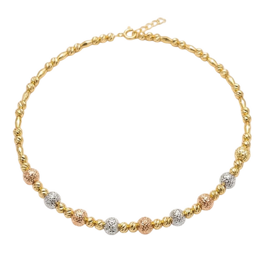 Gold, rose gold, and silver beaded necklace on a white background