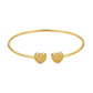 Gold bangle with heart-shaped ends on a white background