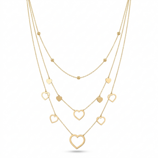 Gold heart-shaped necklace on a white background