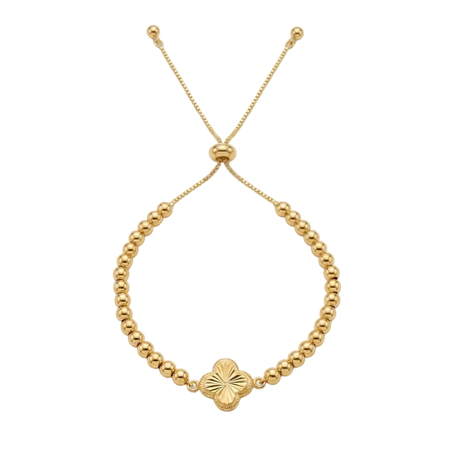 Gold beaded bracelet with a clover-shaped charm on a white background