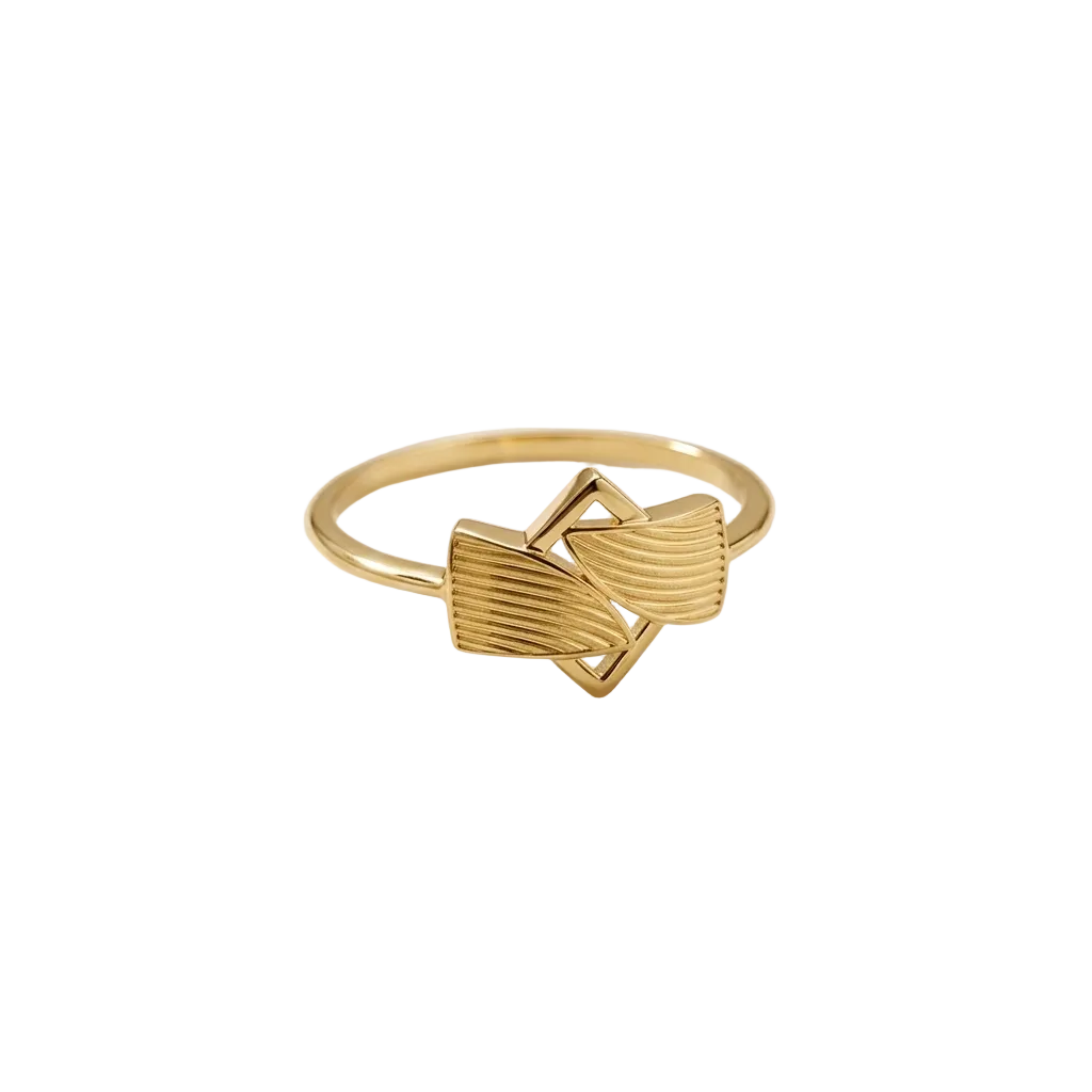 Gold ring with geometric design on a light beige background