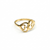Gold ring with intricate design on a white background