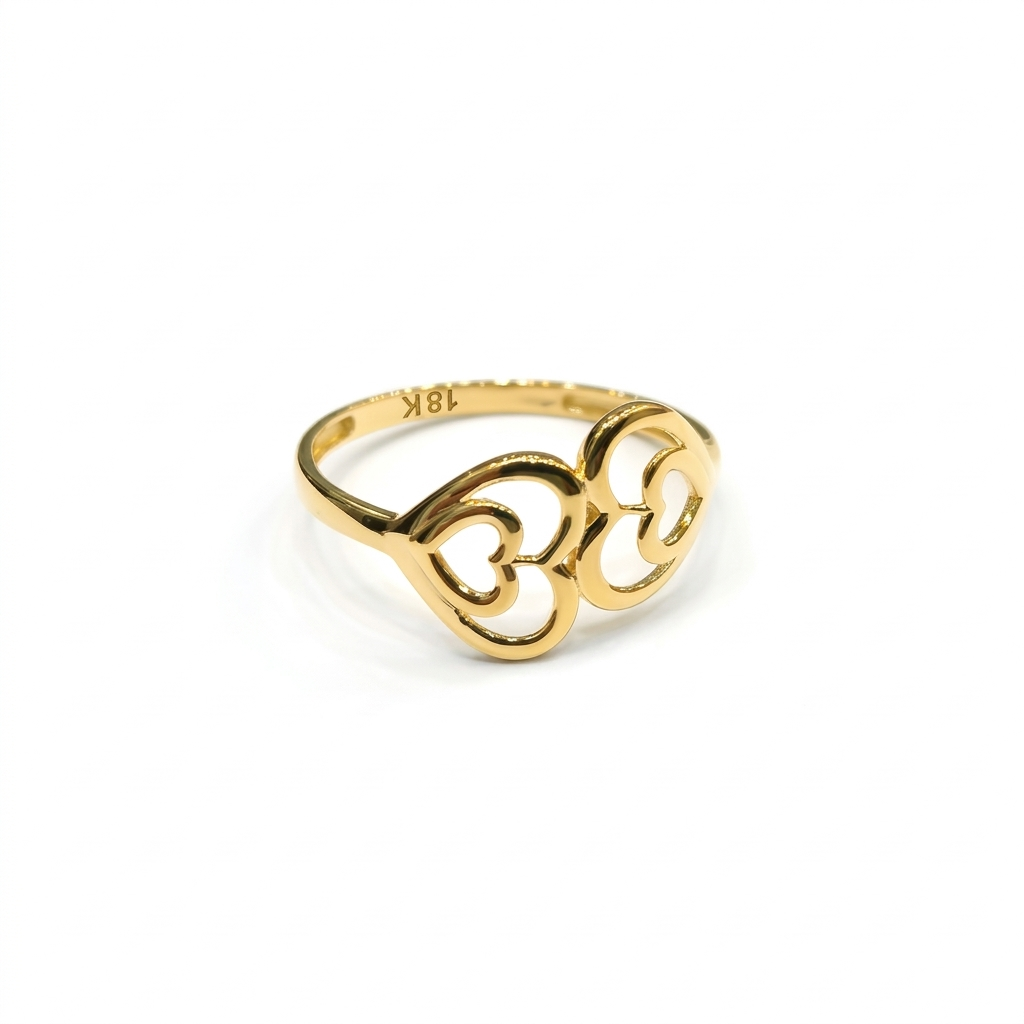 Gold ring with intricate design on a white background
