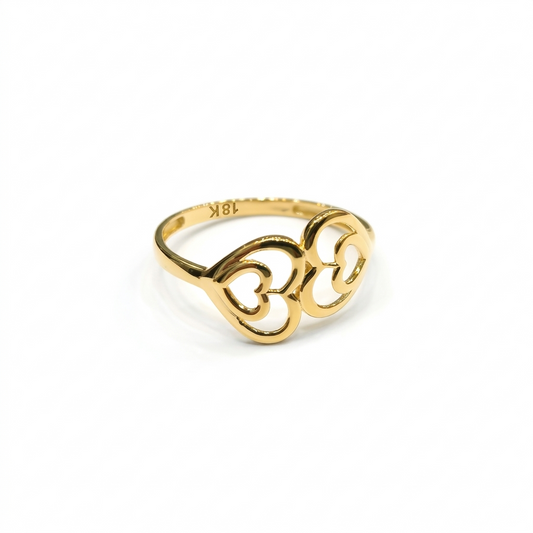 Gold ring with intricate design on a white background