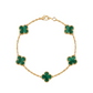 Gold bracelet with green clover-shaped stones on a white background