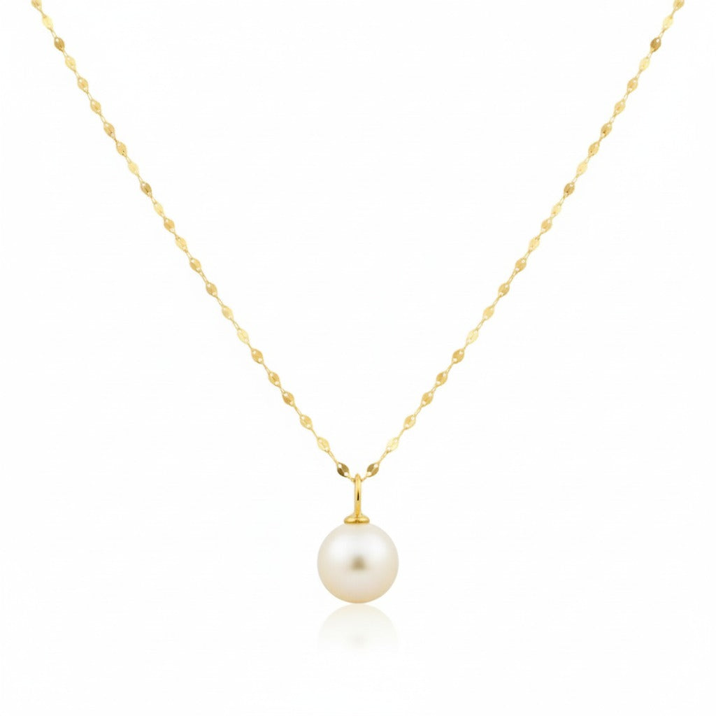 Gold necklace with a single pearl pendant on a white background
