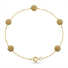 Gold bracelet with spherical beads on a white background